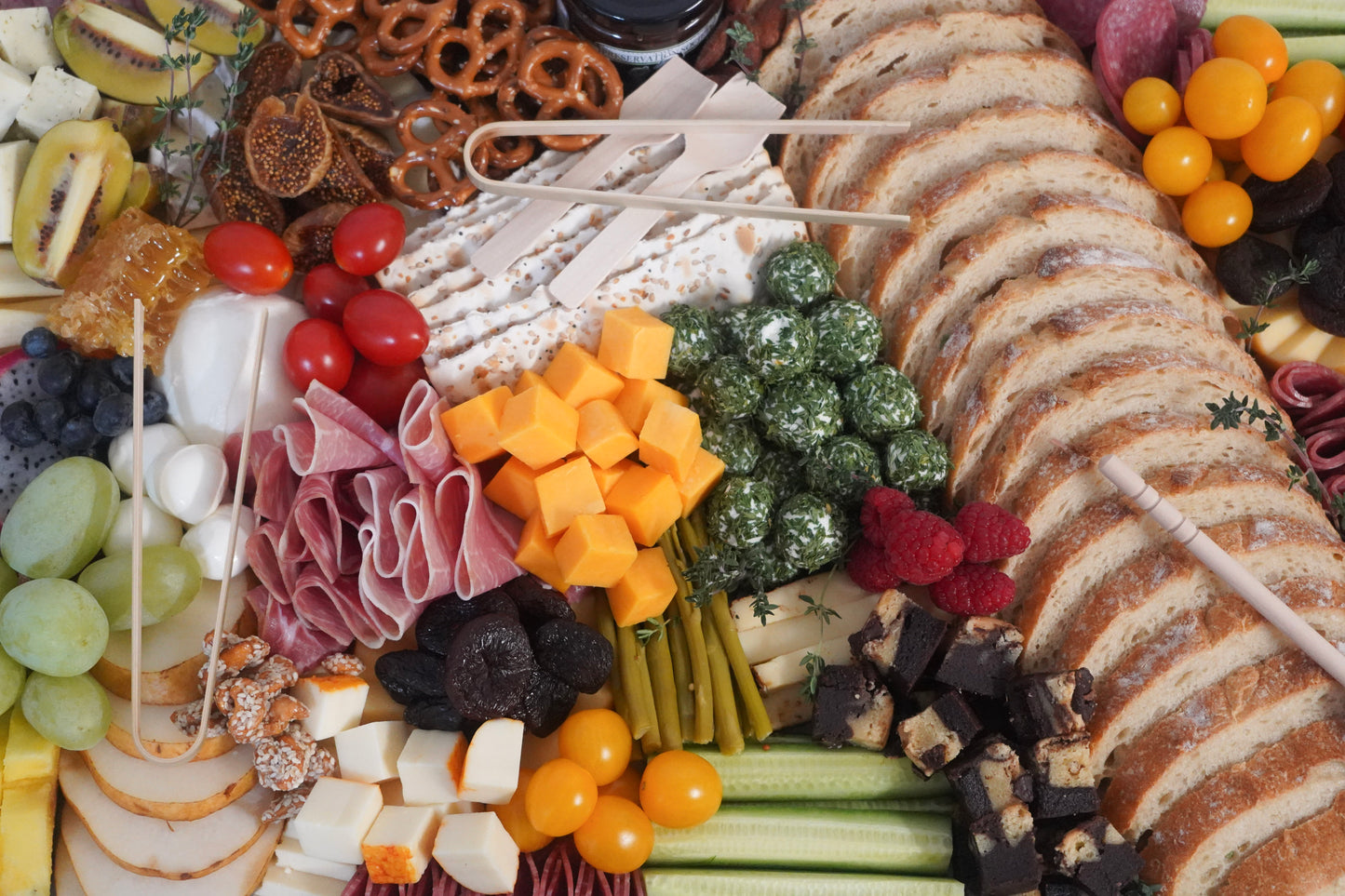 Catering charcuterie board with meats cheeses fruits nuts and crackers
