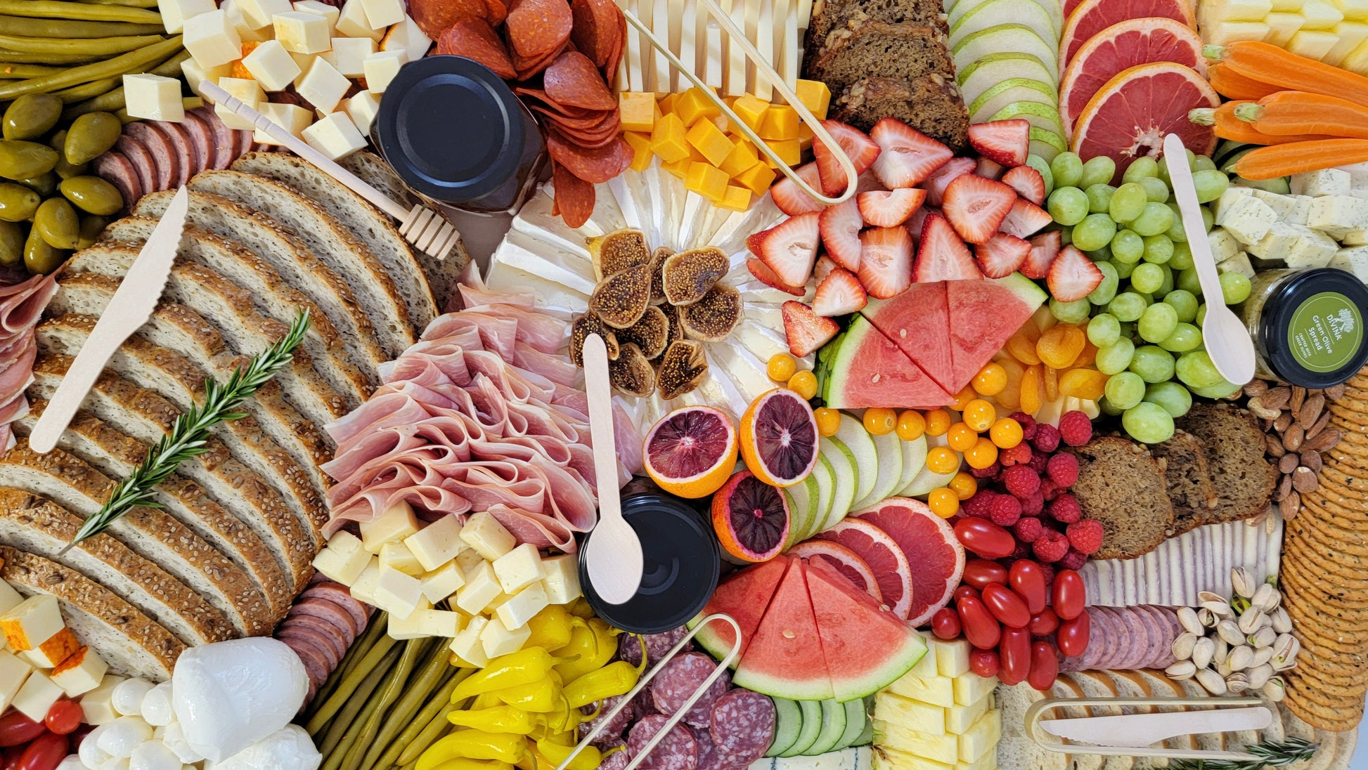 charcuterie board packed with fresh seasonal ingredients