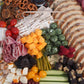 Catering charcuterie board with meats cheeses fruits nuts and crackers