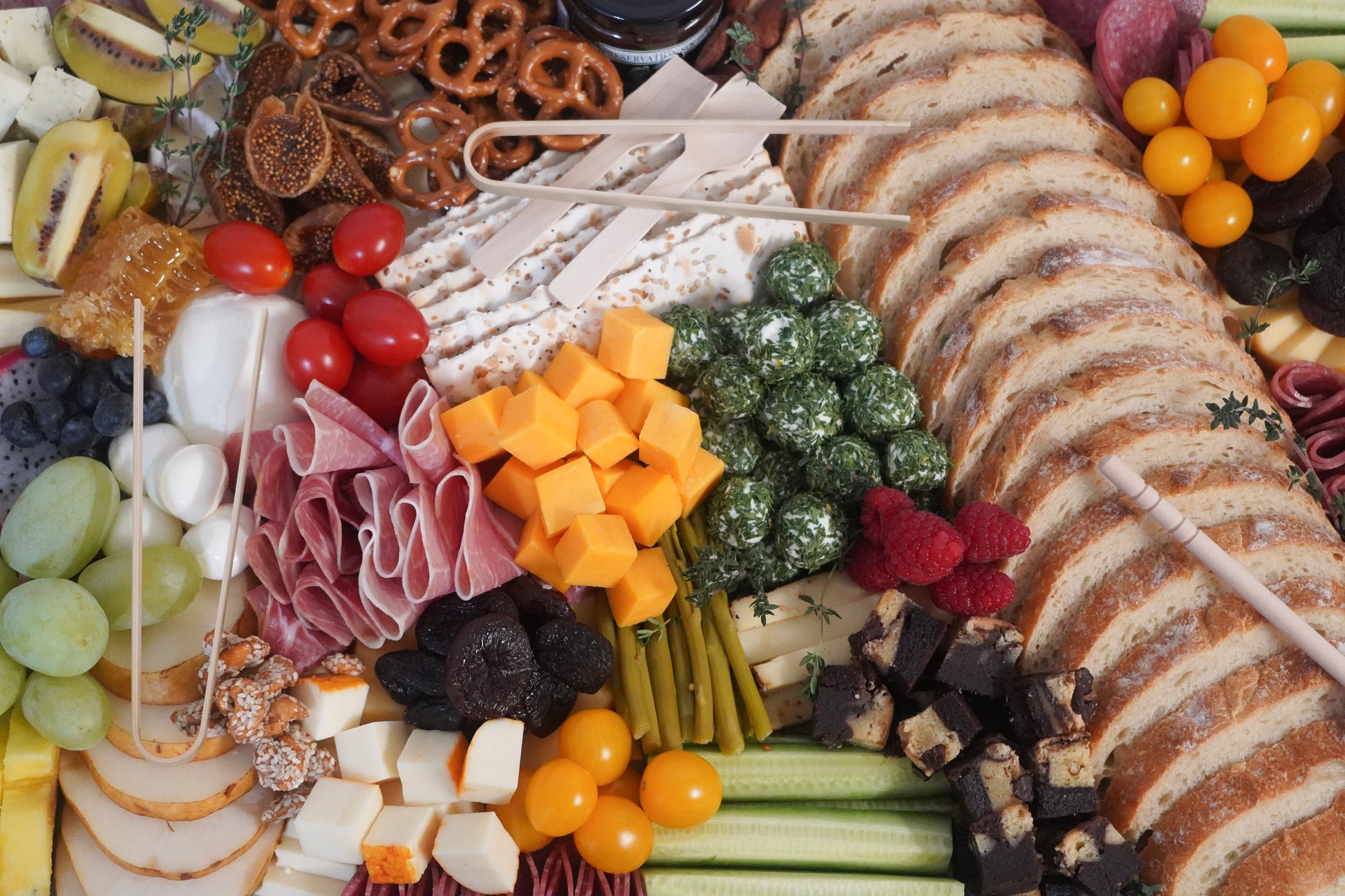 Catering charcuterie board with meats cheeses fruits nuts and crackers