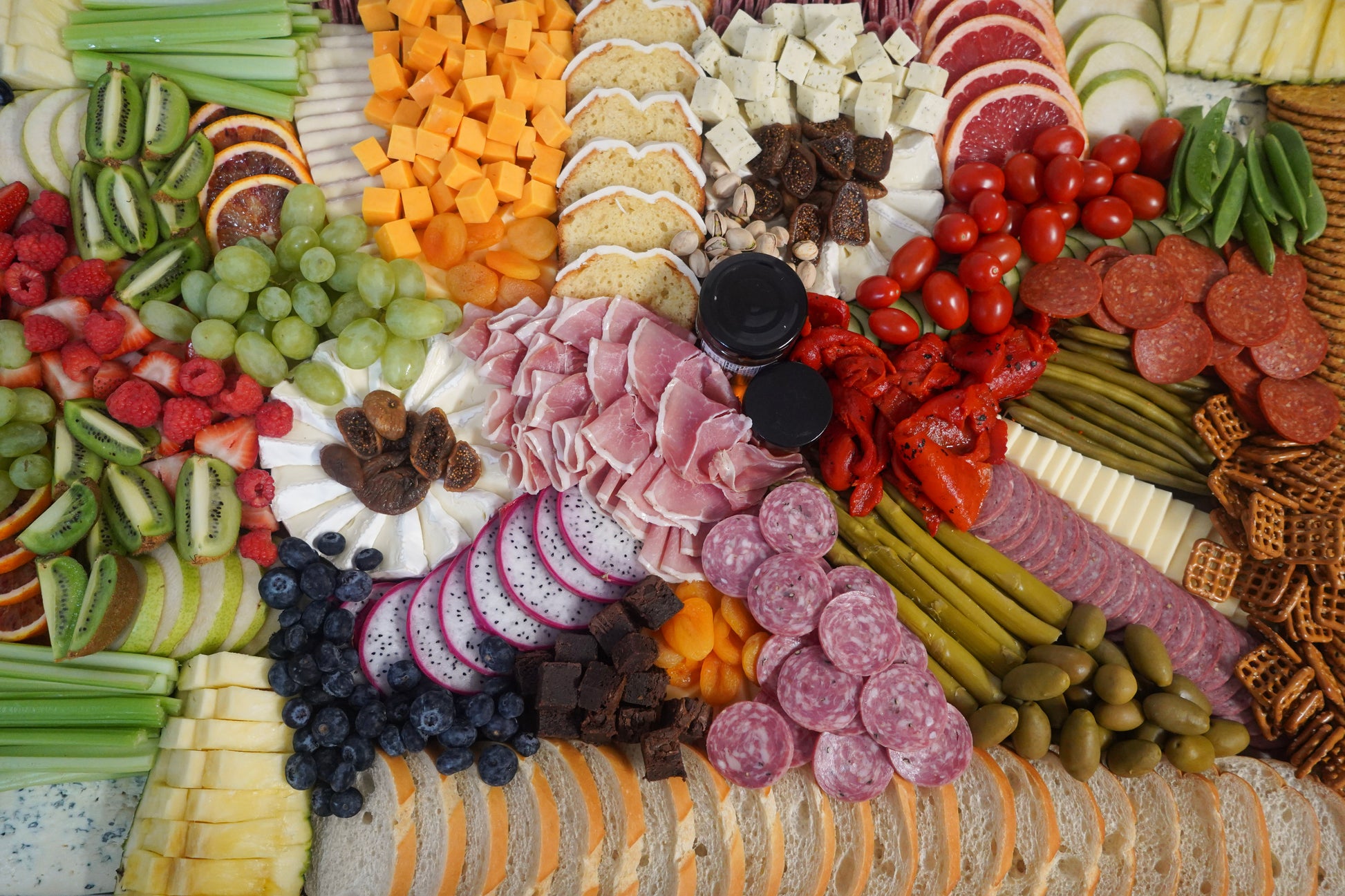 beautiful charcuterie setup with assorted meats cheeses fruits and vegetables