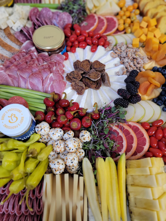 curated charcuterie board with assorted meats cheeses fruits crackers and nuts