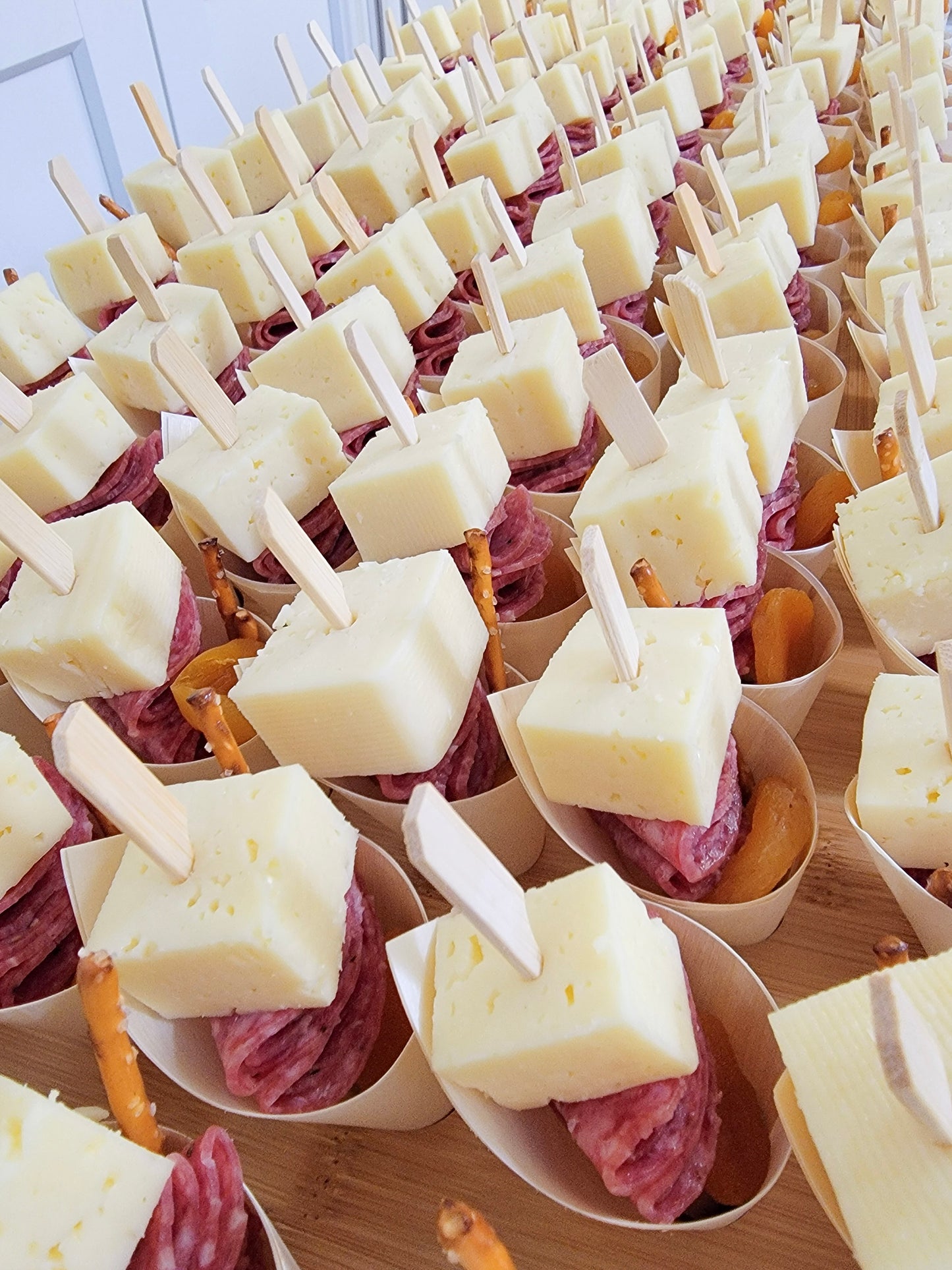 charcuterie cone filled with meat, cheese, fruit, nuts, and snacks arranged for events, parties, and grazing tables