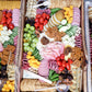 Assorted meats, cheeses, and vegetables on a wooden board