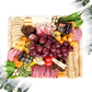 Charcuterie Host board on a bamboo tray with cured meat, cheese, vegetables, fresh fruit, nuts, dried fruit, crackers, honey or preserves, pickled items and sweet treats. Serves 4.