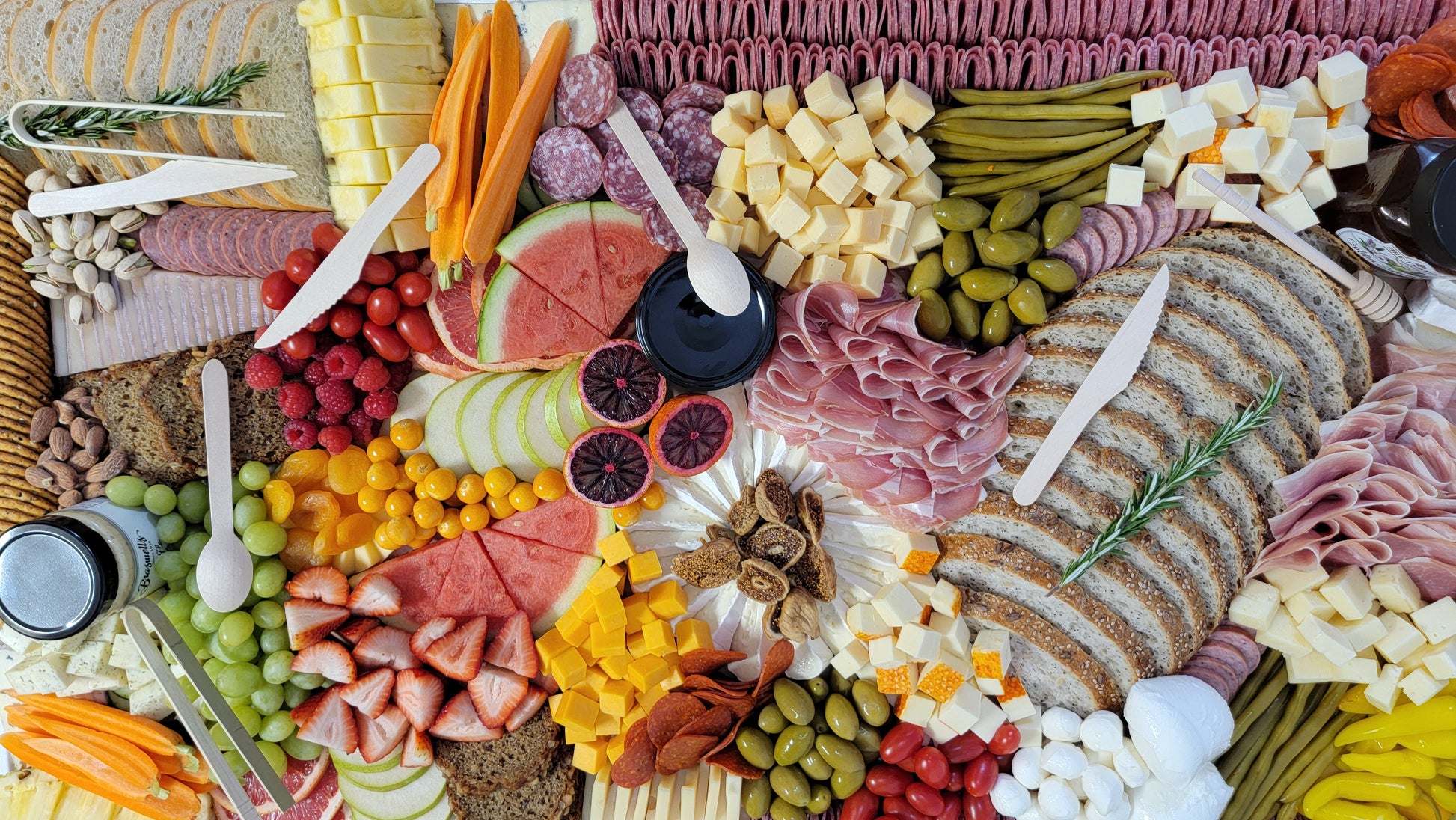 beautifully arranged platter with meats cheeses fruits and vegetables