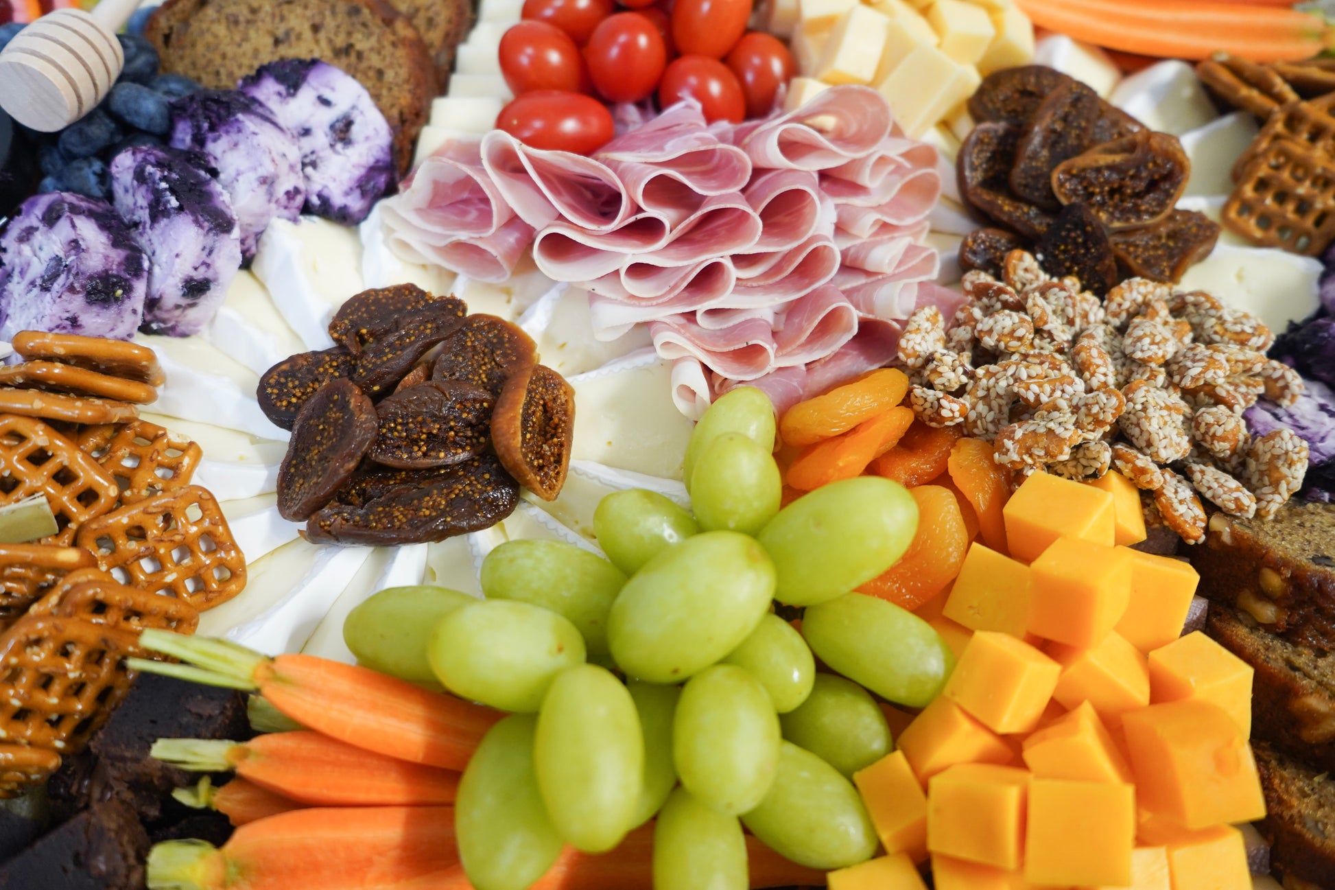 charcuterie display highlighting assorted cheeses meats and fruit