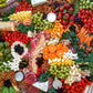 Large charcuterie board filled with assorted meats, cheeses, fruits, and crackers for a large event